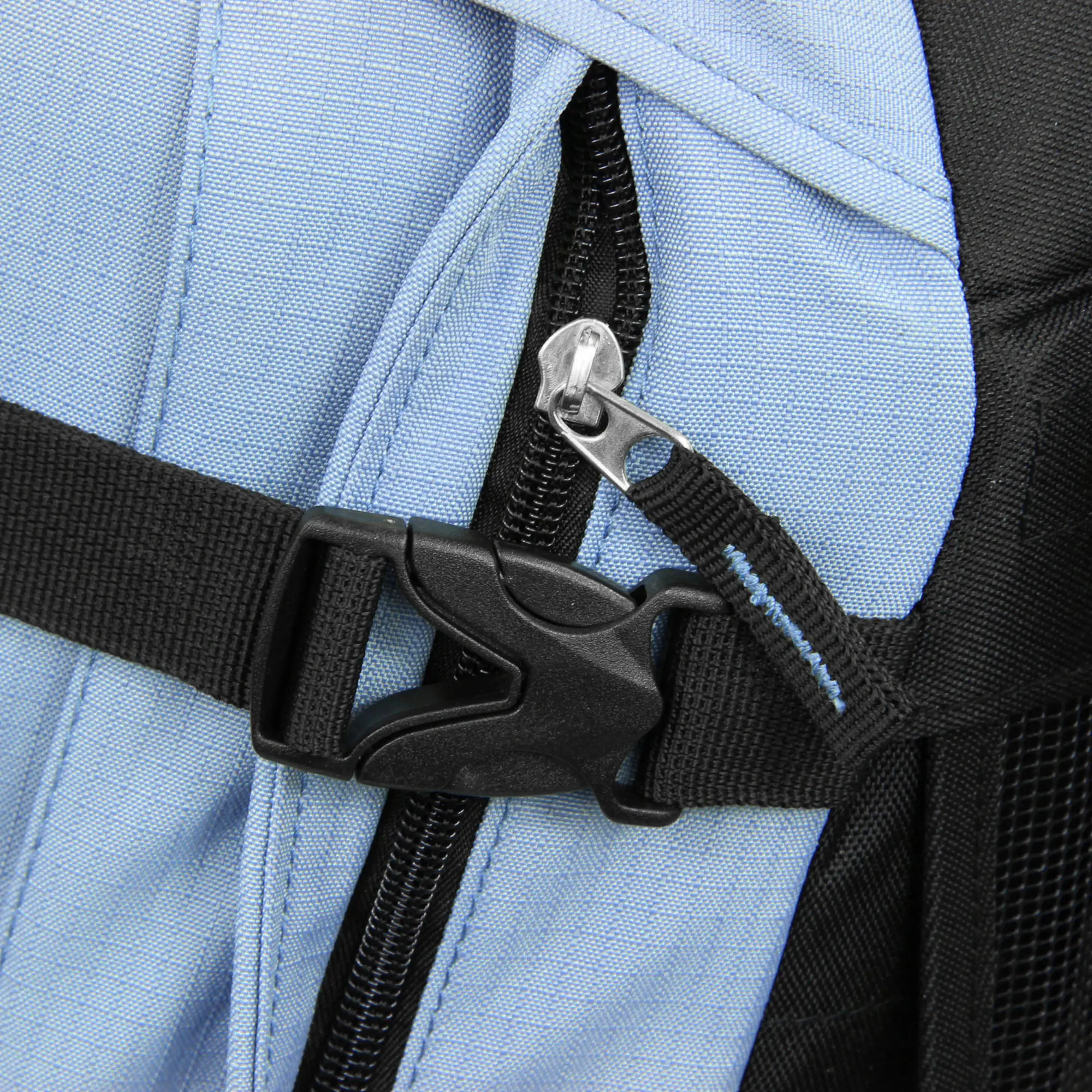 A close-up of a light blue and black backpack strap with a black plastic buckle and a silver zipper pull, showing detailed stitching and fabric texture.